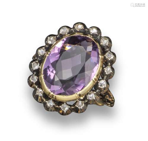 A 19th century amethyst and diamond cluster ring, the oval-shaped amethyst is set within a