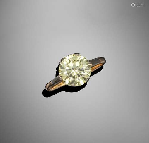 A fancy-coloured diamond solitaire ring, the round brilliant-cut diamond weighs 3.94cts and is set