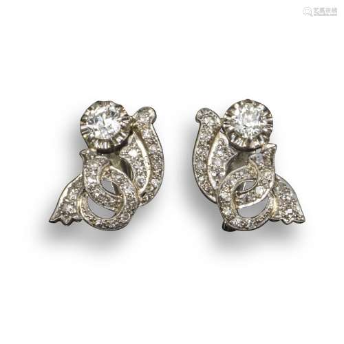 A pair of diamond-set scroll earrings, each earring set with an old circular-cut diamond and smaller