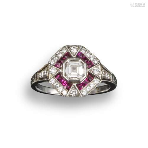 A ruby and diamond cluster ring, the emerald-cut diamond is set within French-cut ruby border and