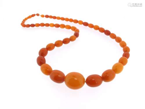 A single-row amber bead necklace, the oval beads graduate from 10 to 26mm long, 64g, 80cm long