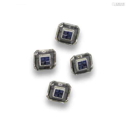 A set of four sapphire and rock crystal studs, set with four calibre-cut sapphires within rock