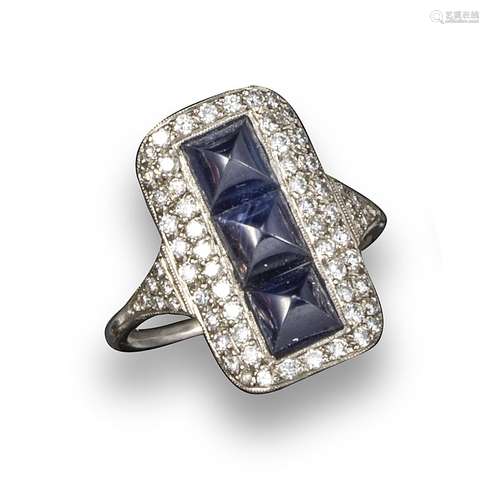 An Art Deco sapphire and diamond plaque ring, the three sugarloaf sapphires are set within a