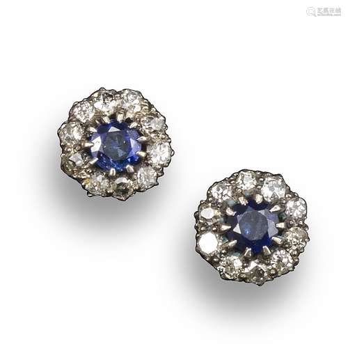 A pair of sapphire and diamond cluster earrings, the circular-cut sapphires are set within a