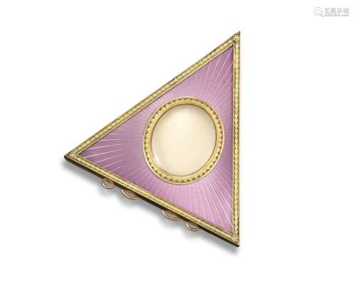 A gold and enamel triangular frame in the Russian style, centred with a glazed oval compartment