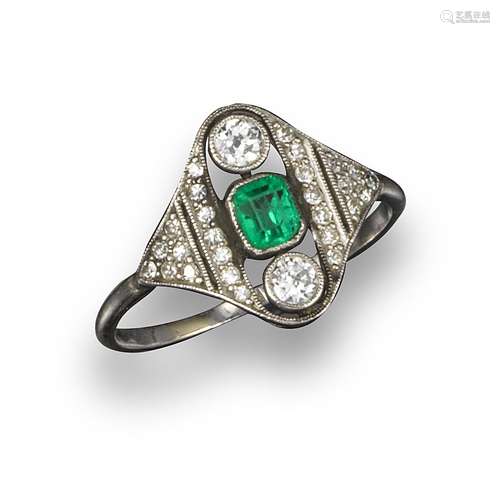 An Edwardian emerald and diamond ring, the centre emerald and two shoulder old circular-cut diamonds