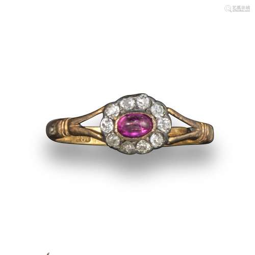 A late 19th century ruby and diamond cluster ring, the oval-shaped ruby cabochon is set within a