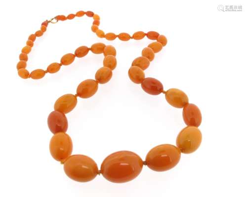 A single-row graduated amber bead necklace, the largest bead measures 2.5 x 1.8cm, 63g, 82cm long