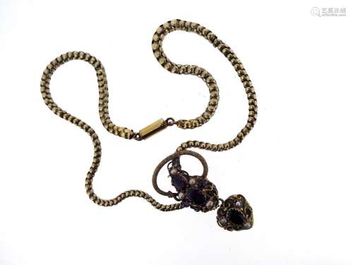 A Victorian garnet set gold snake necklace, the stylised serpent's head set with garnets and pearls,