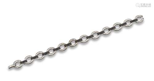 A diamond and onyx bracelet, each oval link millegrain-set with circular-cut diamonds and onyx links