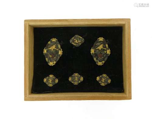A set of Shakudo dress studs, comprising two larger and four smaller studs, depicting cranes amongst