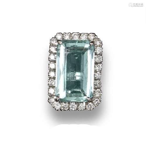 An aquamarine and diamond cluster ring, the rectangular-cut aquamarine set within a surround of