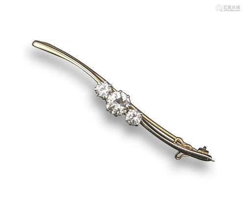 A diamond three stone bar brooch, the three graduated circular-cut diamonds weigh approximately 1.