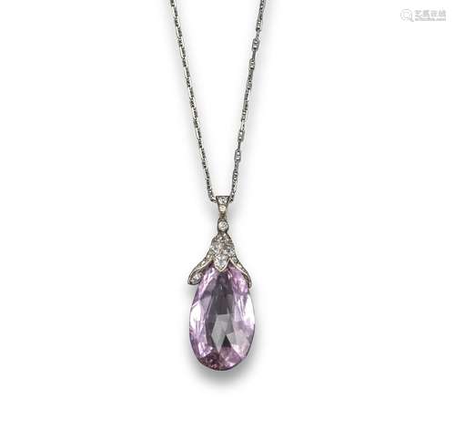 A pink topaz and diamond briolette pendant, the pink topaz suspends from a diamond-set cap in silver