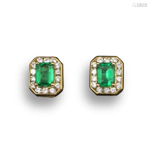 A pair of emerald and diamond cluster earrings, the emerald-cut emeralds are set within a surround