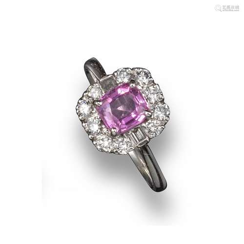 A pink sapphire and diamond-set cluster ring, the sapphire set within a surround of ten round