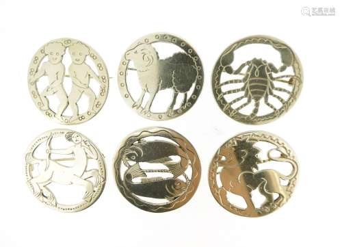 Six silver zodiac brooches by Jessie Murphy, the circular silver brooches depicting Leo, Pisces,