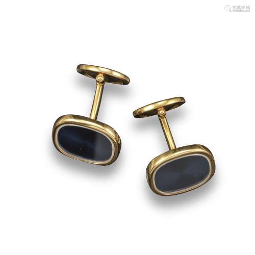 A pair of yellow gold cufflinks by Patek Philippe, the larger oval link with steel-coloured enamel