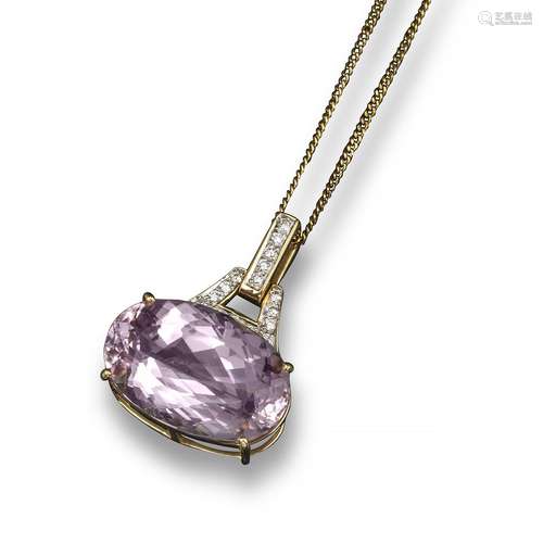 A kunzite and diamond-set gold pendant, the oval shaped kunzite set in yellow gold and with