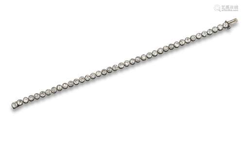 An early 20th century diamond line bracelet, the articulated engraved platinum collets are