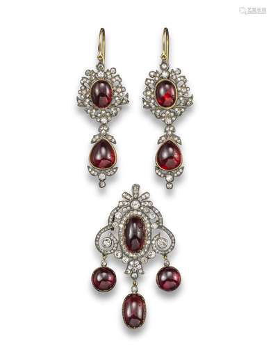 A pair of garnet and diamond drop earrings, the oval garnet cabochons set within a foliate diamond