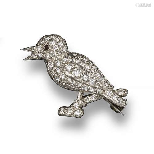 A diamond-set kookaburra brooch, pave-set with graduated circular-cut diamonds and a garnet eye in