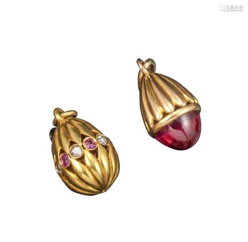 Two miniature egg pendants, one with fluted gold upper section and set with a cabochon red stone (