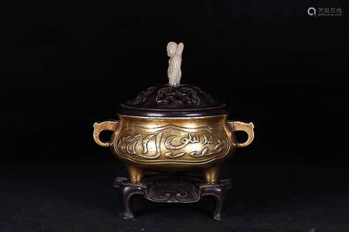 A QING DYNASTY GILT BRONZE CENSER WITH RED SANDALWOOD BASE