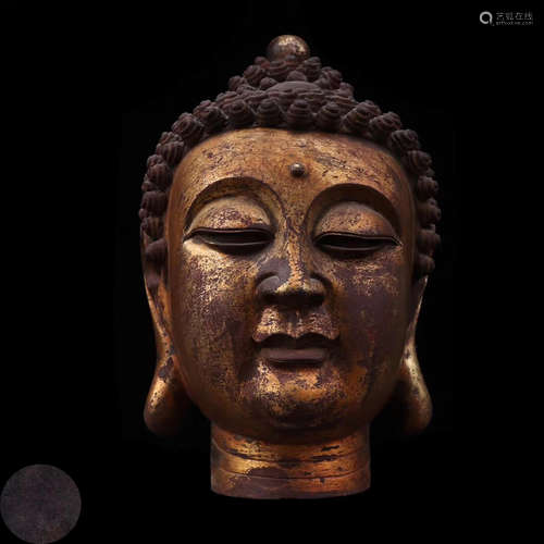 A GILT BRONZE MOLDED BUDDHA HEAD STATUE