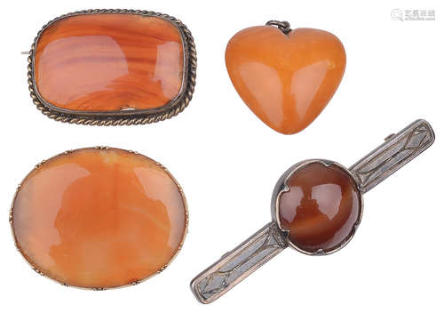 A butterscotch amber heart pendant; three carnelian set brooches(4)