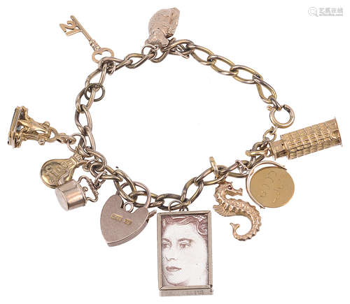 A collection of gold bracelet charms suspended from a gilt bracelet