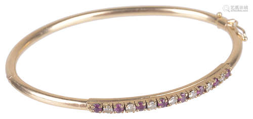 A delicate Continental ruby and diamond set hinged bangle