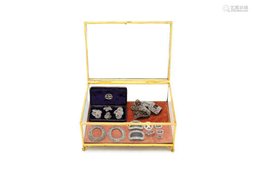 A collection of late 18th and 19th century cut steel buckles, buttons and ornaments together with gilt brass glazed miniature display box