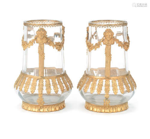 the glass in the Baccarat style A pair of early 20th century French gilt bronze mounted clear glass vases