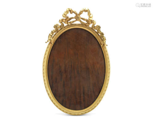 in the early 19th century style A large gilt bronze oval photograph frame
