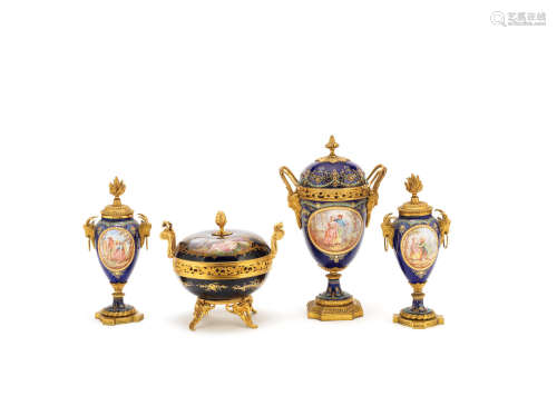 all in the Louis XVI style A pair of late 19th century French gilt bronze mounted Sevres style cobalt blue porcelain cassolettes together with a similar garniture vase and cover, and a Sevres bowl and cover