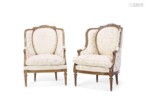 in the Louis XVI style A pair of French late 19th/early 20th century carved wingback bergeres
