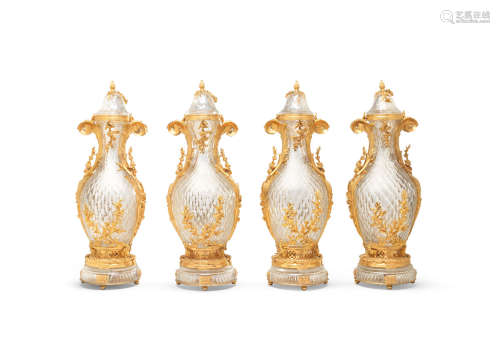 20th century, in the Baccarat style A set of four impressive gilt bronze mounted and cut glass garniture vases and covers