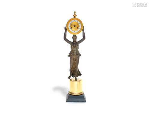 in the Empire style A 19th century French patinated, gilt and polished bronze figural clock