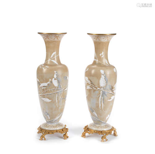 the glass possibly attributable to Baccarat, the naturalistc footed mounts probably of a later date  A pair of gilt bronze mounted late 19th century opaline glass garniture vases