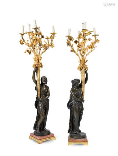 the figures representing Summer and Autumn and from the Four Seasons and cast after models by Jean Francois Lorta (French,1752-1837)  A pair of impressive 19th century French patinated and gilt bronze figural five light torchère candelabra