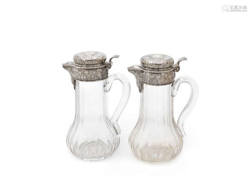 by Tiffany & Co, circa 1882, pattern number 6789  (2) A pair of silver-mounted claret jugs