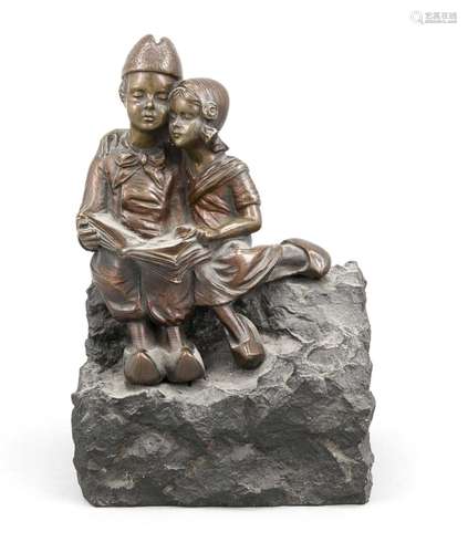 Sculptor around 1900, Dutch couple huddled together while reading together,