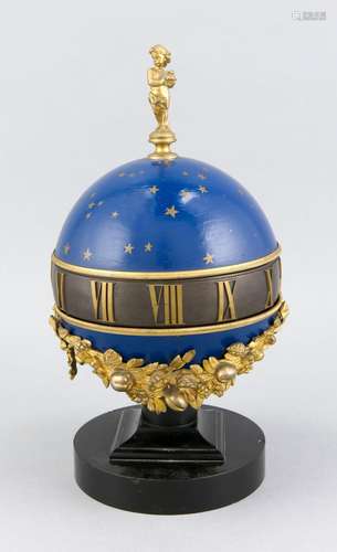 Pendulum in globe optics, gilt scrollwork covers the lower part of the marb