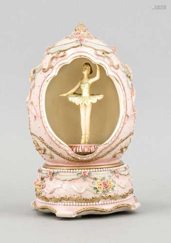 Music box in the form of an egg, standing in it rotating dancer, pink paint