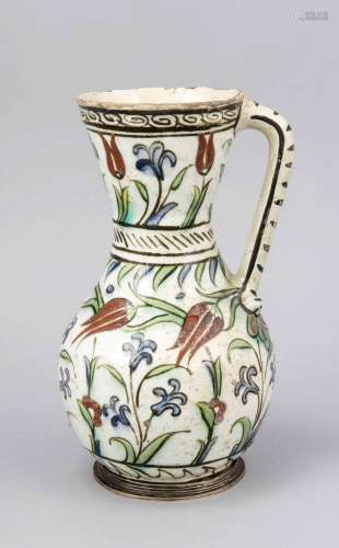 An Iznik pottery pitcher. Handle restored. H. 23 cm