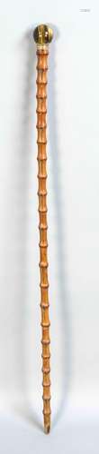 A walking stick around 1900, bamboo shaft, horn, brass-mounted tiger eye ba