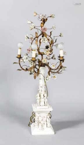 Lamp on a white porcelain base, c. 1900, a pedestal surrounded by four chil