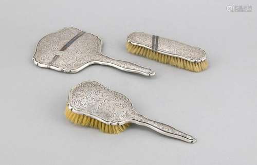 Three pieces of a toilet set, 20th century, plated, hand mirror and 2 brush