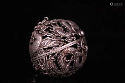 A SILVER MOLDED ROUND ORNAMENT